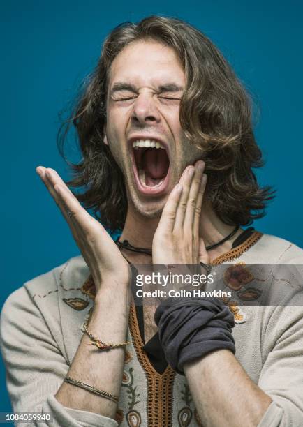 hippie male slapping himself in the face - slapping face stock pictures, royalty-free photos & images
