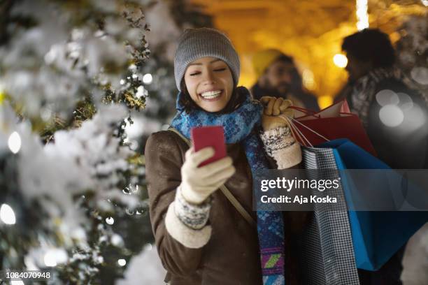 hey, look what i what i bought for christmas. - woman snow outside night stock pictures, royalty-free photos & images