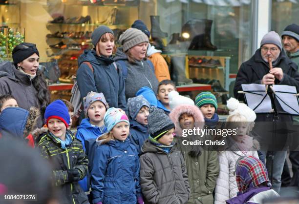 christmas singing - carol singer stock pictures, royalty-free photos & images