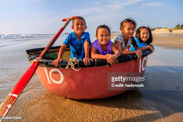 group of vietnamese children have fun on the beach, vietnam - vietnam beach stock pictures, royalty-free photos & images