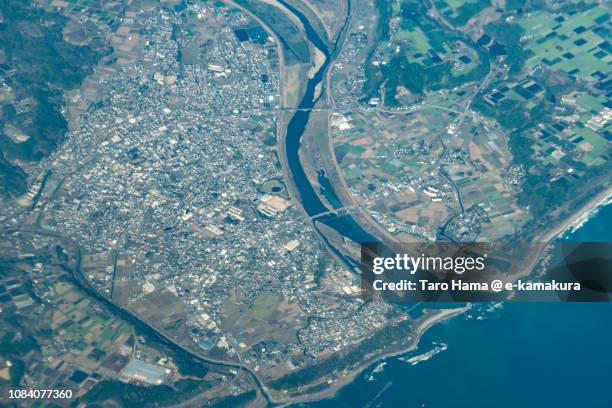 pacific ocean and takanabe town in miyazaki prefecture in japan daytime aerial view from airplane - miyazaki prefecture stock pictures, royalty-free photos & images