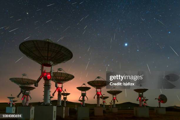 satellite antenna array under the meteor shower - meteor shower stock pictures, royalty-free photos & images