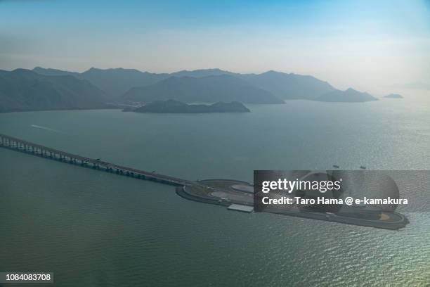 south china sea, lantau island and hong kong-zhuhai-macao bridge in hong kong daytime aerial view from airplane - south china sea island stock pictures, royalty-free photos & images