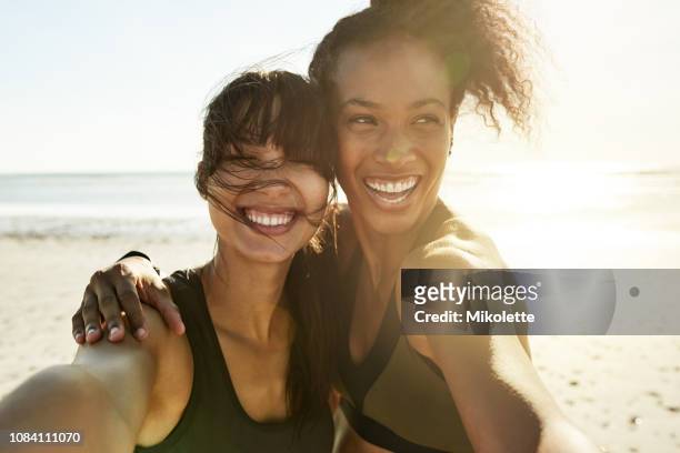 we can't help but feel great - two women running stock pictures, royalty-free photos & images