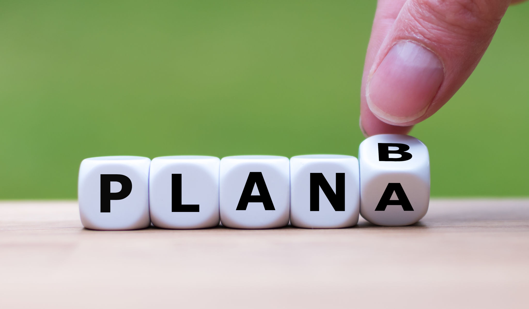 Time for Plan B. Hand is turning a dice and changes the word Time for Plan B. Hand is turning a dice and changes the word
