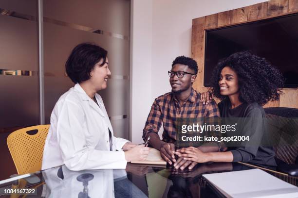 couple on doctors consultation - in vitro fertilization stock pictures, royalty-free photos & images