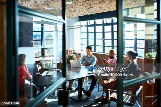 looking through board room door at business strategy meeting - asian man sitting casual imagens e fotografias de stock