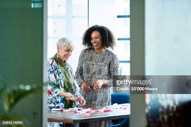 cheerful businesswoman and senior manager planning with sticky notes - casual woman business stock pictures, royalty-free photos & images