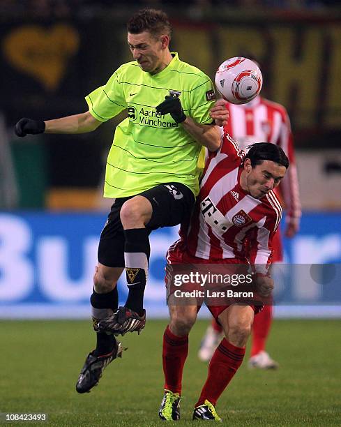 Manuel Junglas of Aachen challenges Danijel Pranjic of Muenchen during the DFB Cup quarter final match between Alemannia Aachen and Bayern Muenchen...