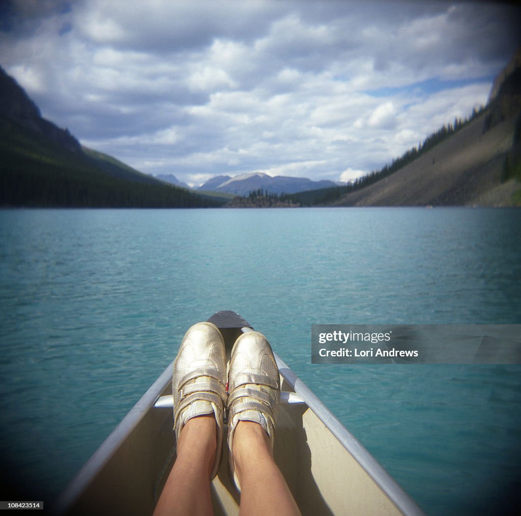 Golden sneakers and an azure mountain lake