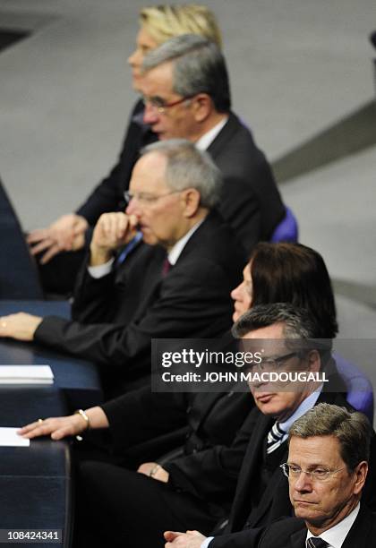 German Foreign Minister and vice-chancellor Guido Westerwelle , German Interior Minister Thomas de Maiziere and other cabinet members listen to...