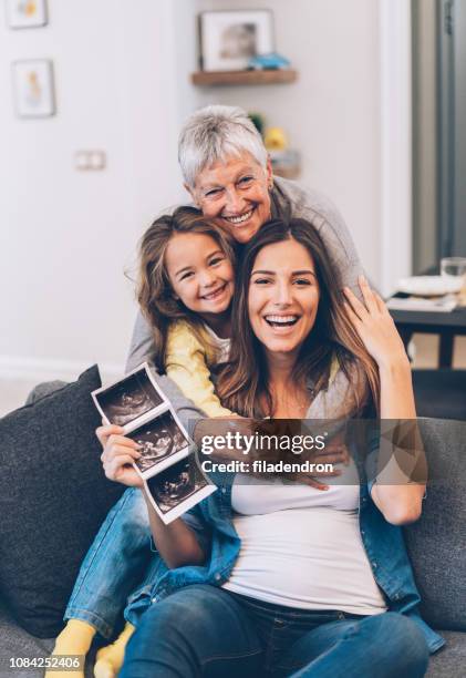 grandmother, mother, daughter and expectant baby - two generation family stock pictures, royalty-free photos & images