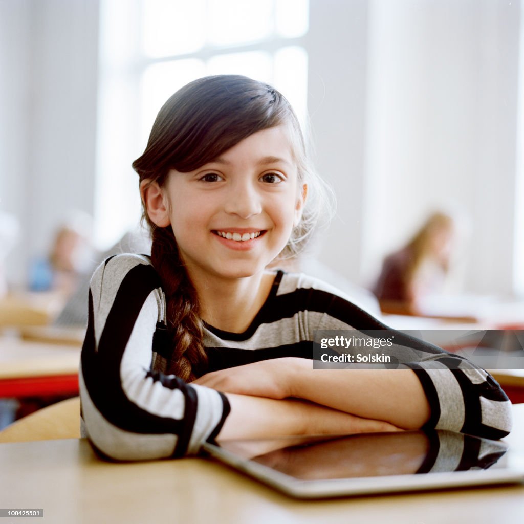 Girl in school with portable computer