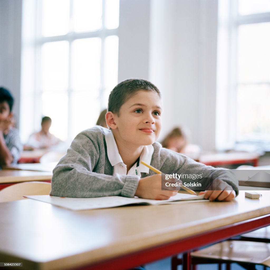 Boy sitting in school class