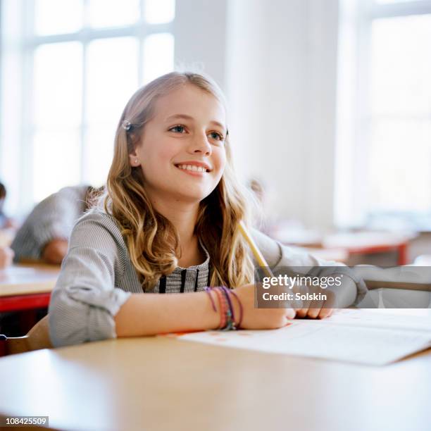 girl in school class - blonde girl smiling stock-fotos und bilder