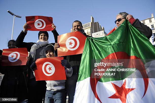 People hold Tunisian and Algerian flags on January 22, 2011 in Marseille, southern France, in support of local pro-democracy demonstrations in...