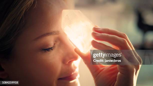 woman's head with a healing crystal. - new age stock pictures, royalty-free photos & images