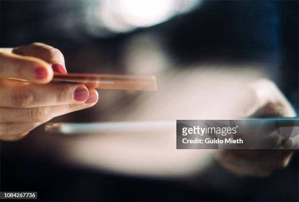 shopping online with tablet pc and credit card on hand. - nfc payment stock pictures, royalty-free photos & images