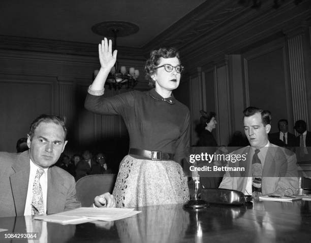 Mrs. Diana Wolman, a school teacher at Thomas Jefferson High School in Brooklyn, is shown being sworn in as a witness before the Senate Subcommittee...