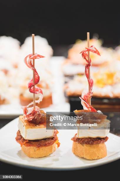 traditional pinchos (pintxos) snacks in san sebastian - spiked imagens e fotografias de stock