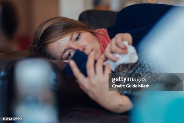 ill woman using mobile phone. - illness bildbanksfoton och bilder