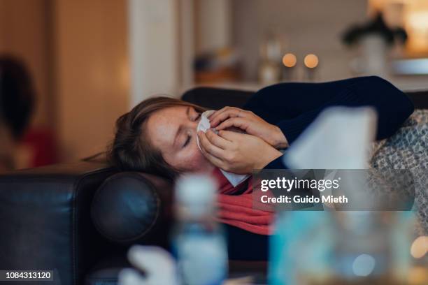 ill woman using tissue paper. - alleen één oudere vrouw stockfoto's en -beelden