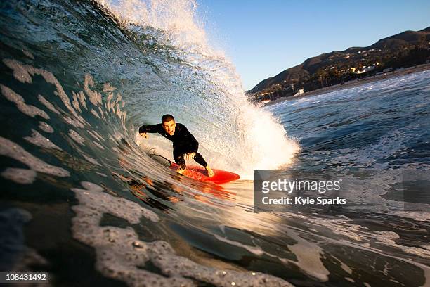 a male surfer gets barreled at zuma beach in malibu, california. - zuma beach foto e immagini stock