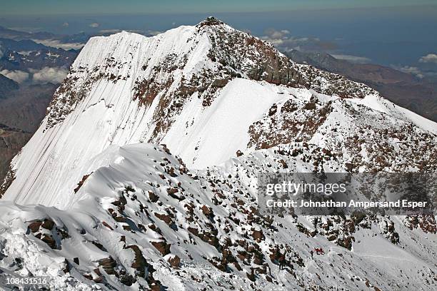 aconcagua south summit view and climbers ascending, from aconcagua main summit at 6962 m. - mount aconcagua stock pictures, royalty-free photos & images