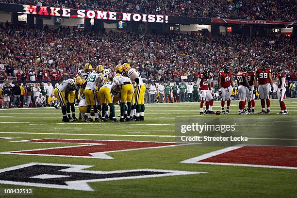 The Green Bay Packers offense huddles up against the Atlanta Falcons defense during their 2011 NFC divisional playoff game at Georgia Dome on January...