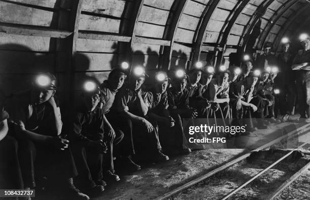 Group of trainee miners wait underground for a train that will take them to the coal face at the Markham colliery in Derbyshire, England circa 1950.