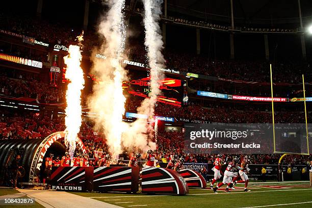 The Atlanta Falcons run onto the field during pregame festivities against the Green Bay Packers during their 2011 NFC divisional playoff game at...