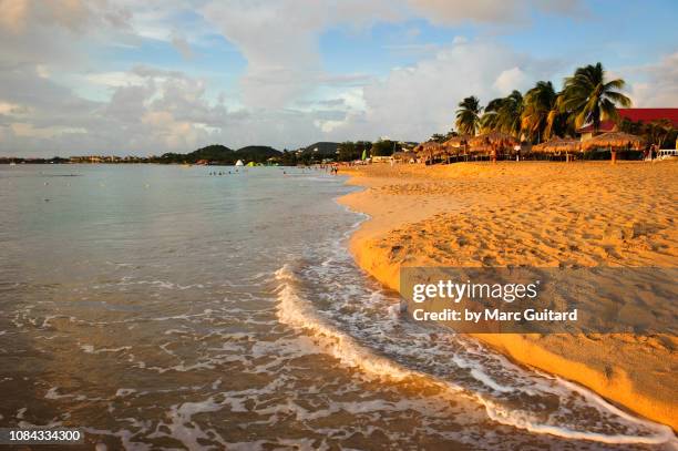 sunset on reduit beach, gros islet, saint lucia - gros islet stock pictures, royalty-free photos & images