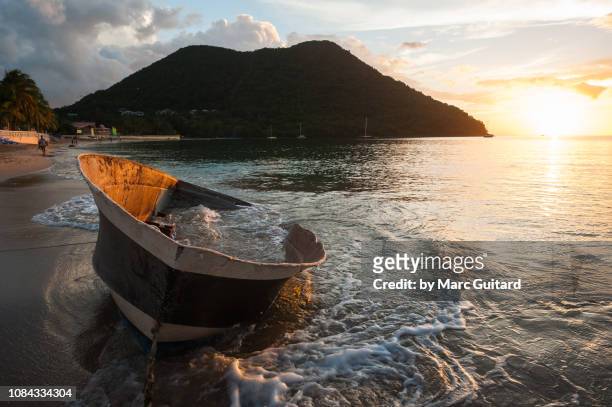 wrecked boat on reduit beach, gros islet, saint lucia - gros islet stock pictures, royalty-free photos & images