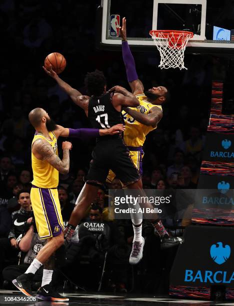 Ed Davis of the Brooklyn Nets shoots against LeBron James of the Los Angeles Lakers during their game at the Barclays Center on December 18, 2018 in...