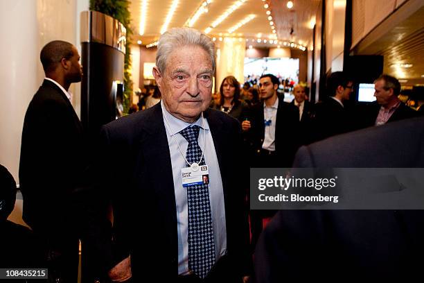 George Soros, founder of Soros Management Fund LLC, walks in between sessions on the second day of the World Economic Forum Annual Meeting 2011 in...