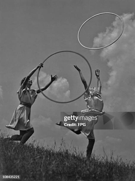 Two women throwing hoops circa 1960.
