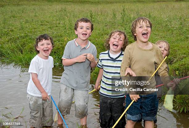 group of boys singing in the river - boy river looking at camera stock pictures, royalty-free photos & images