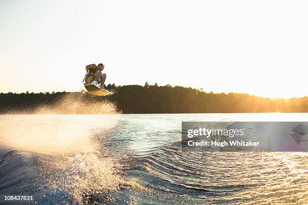 wakeboarder at sunset - wakeboarding stock pictures, royalty-free photos & images