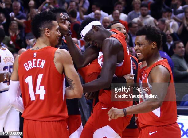 Pascal Siakam of the Toronto Raptors celebrates with teammates after sinking the winning basket following the second half of an NBA game against the...