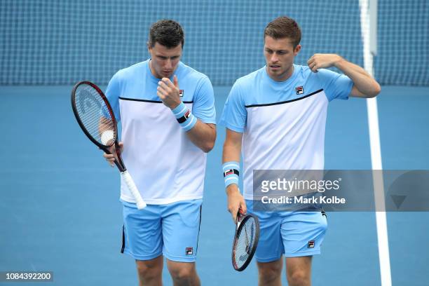 Neal Skupski of Great Britain and Ken Skupski of Great Britain talk tactics in their second round match against Henri Kontinen of Finland and John...