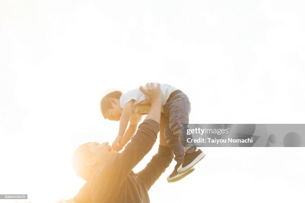 A father lifting his son