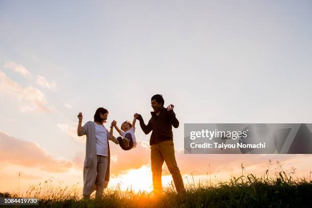 child playing hands with parents - holding hands ストックフォトと画像