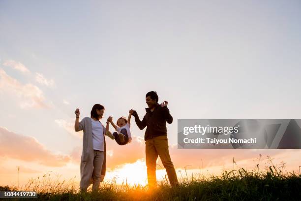 child playing hands with parents - family side by side stock pictures, royalty-free photos & images