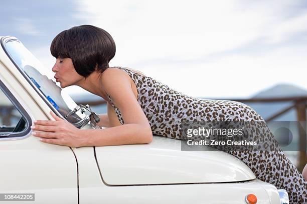 woman kissing a car - auto küssen stock-fotos und bilder