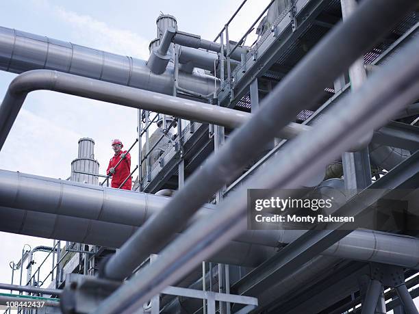 worker on underground gas storage plant - vorratstank stock-fotos und bilder