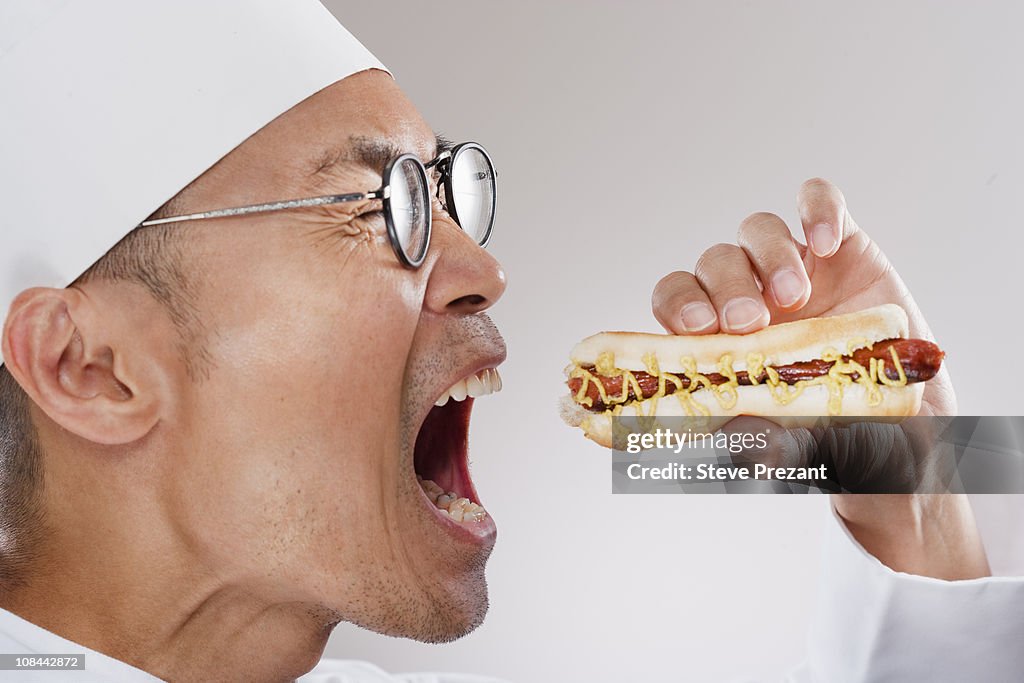 Chef about to eat a hotdog