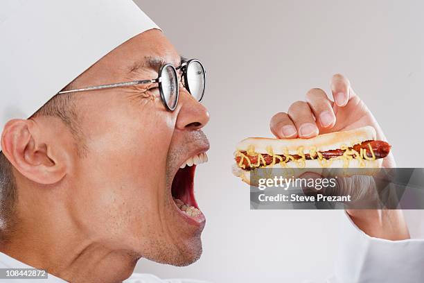 chef about to eat a hotdog - mouth open profile stock pictures, royalty-free photos & images