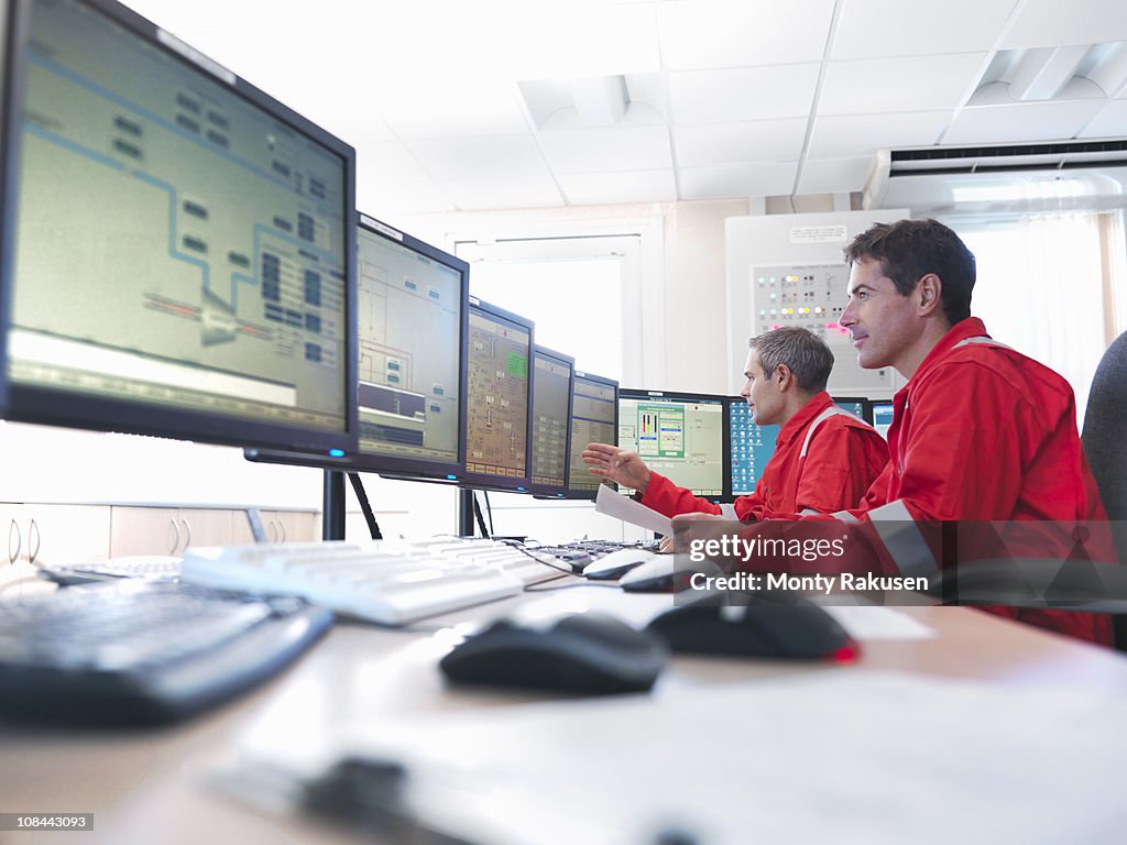 Workers in control room of gas plant