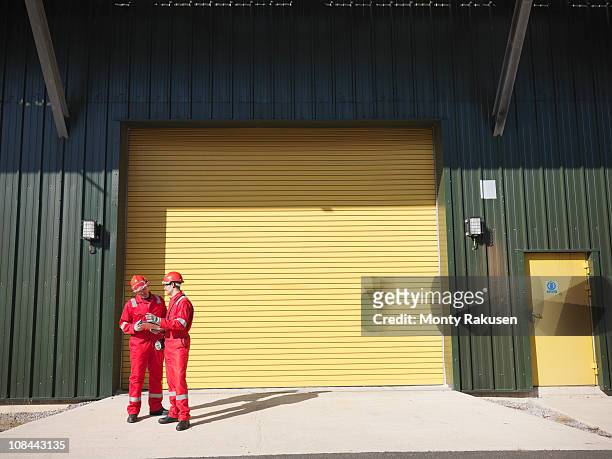 workers in front of industrial plant - auto repair shop exterior stock pictures, royalty-free photos & images