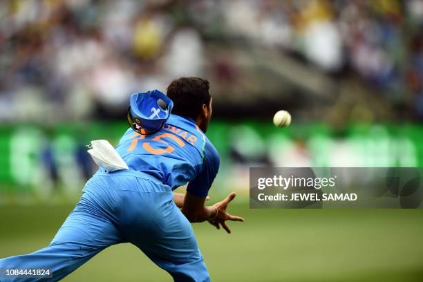 India's Bhuvneshwar Kumar catches the ball to dismiss Australia's Glenn Maxwell during the third one-day international cricket match between...